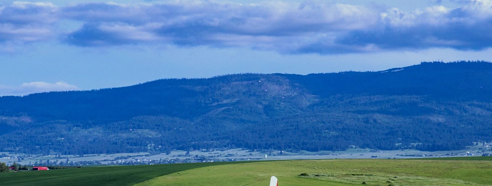 Forested hills above Northwest farmland